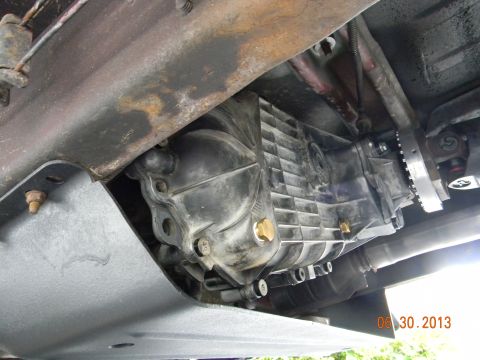 1995 Ford Bronco - Transfer case and driveshaft components visible from underneath a vehicle.