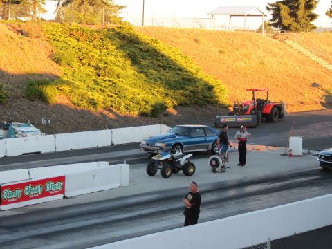 1990 Ford Mustang - A blue 1990 Ford Mustang coupe is parked on a drag strip, with a number 330 visible on its door.