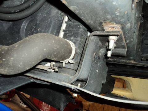 2004 Mercury Grand Marquis - Underside view of a vehicle's cooling system components, including a radiator hose and mounting hardware.