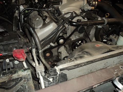 2004 Mercury Grand Marquis - Close-up view of an engine bay, showing various mechanical components and hoses.