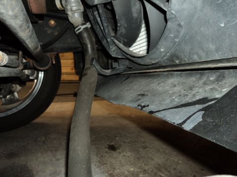 2004 Mercury Grand Marquis - Close-up view of the undercarriage of a vehicle, revealing mechanical components and a tire.
