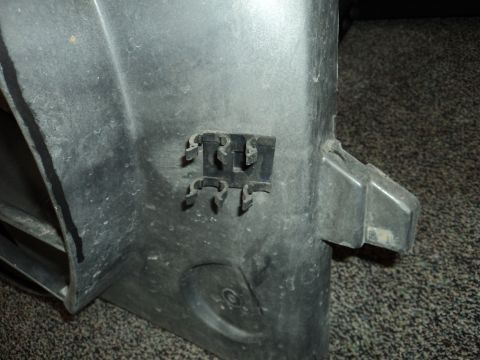 2004 Mercury Grand Marquis - This is a close-up of a plastic automotive part with multiple clips.
