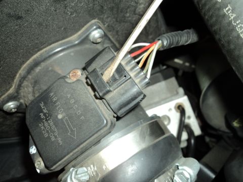 2004 Mercury Grand Marquis - Close-up of a mass air flow sensor, showing part number and air flow indicator.