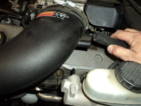 2004 Mercury Grand Marquis - Close-up of an engine bay, focusing on an aftermarket air intake system and brake fluid reservoir.