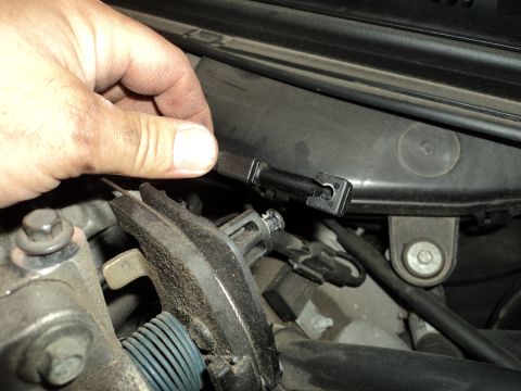 2004 Mercury Grand Marquis - A hand disconnects an electrical connector from a vehicle's engine bay components.