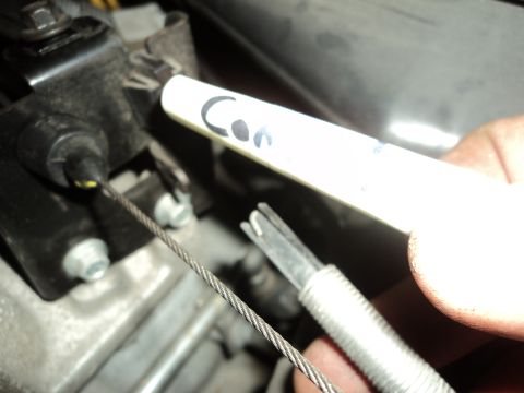 2004 Mercury Grand Marquis - A hand holds a marker near a cable attached to an engine component.