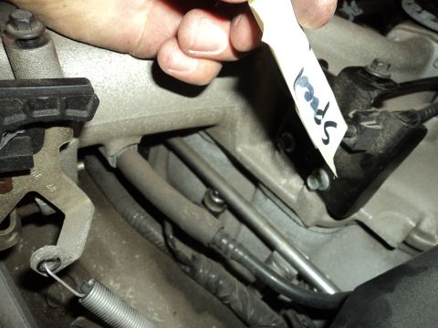 2004 Mercury Grand Marquis - Close-up of an engine component with a handwritten label indicating 'Speed'.