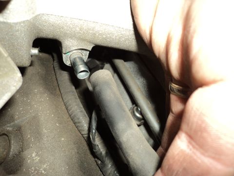 2004 Mercury Grand Marquis - Detail of an engine component with a hose and fitting, possibly during maintenance or modification.