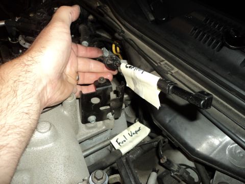 2004 Mercury Grand Marquis - A hand manipulates a sensor in the engine bay, with labels indicating "Fuel Vapor" and "Control" for reference.