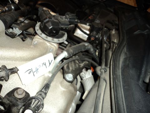 2004 Mercury Grand Marquis - Close-up view of an engine bay, a handwritten tag identifying a throttle component.