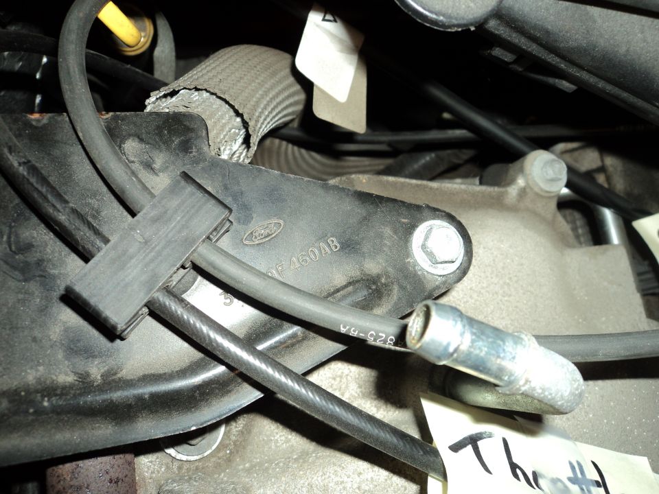 Close-up of a Ford engine bracket with part number F-4604B visible
