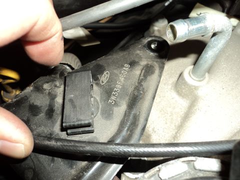 2004 Mercury Grand Marquis - A close-up view of a Ford branded engine component, showing a part number and a black clip.