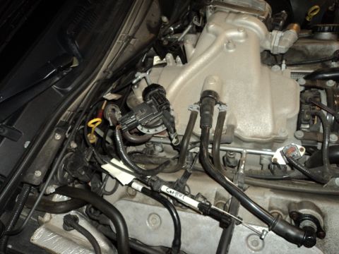 2004 Mercury Grand Marquis - Close-up of an engine bay, focusing on fuel injectors and intake manifold components.