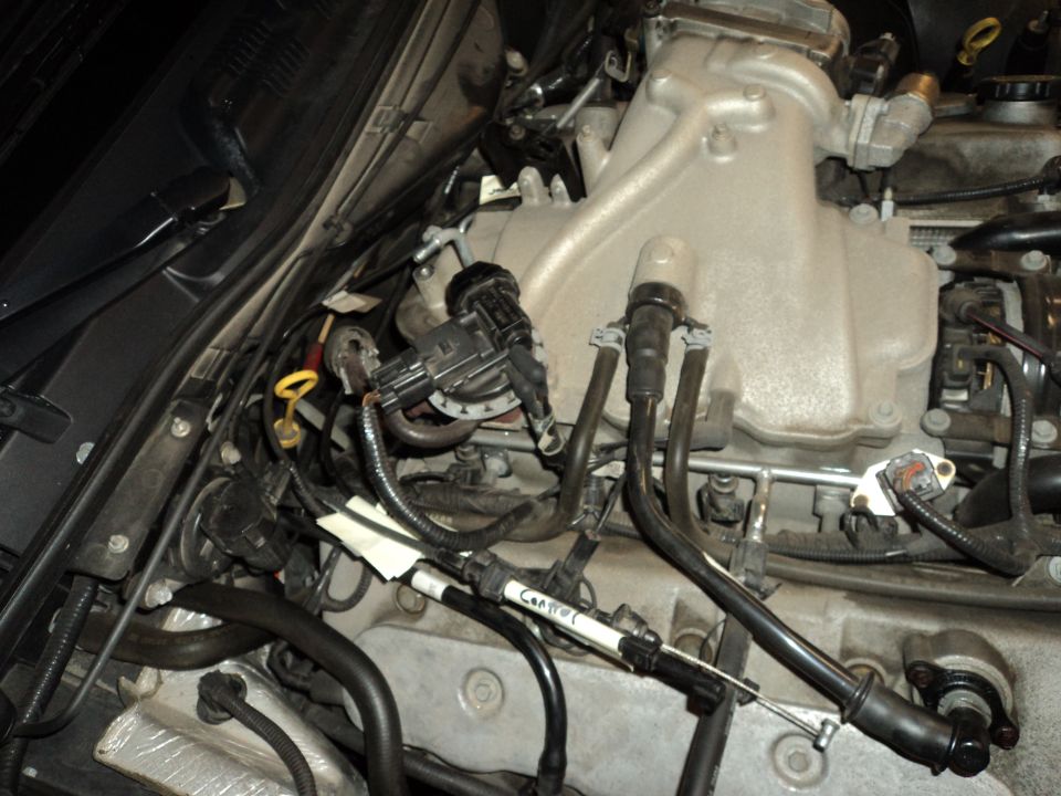 Engine bay showing fuel injectors and intake manifold. Cable labeled 'Control' is visible