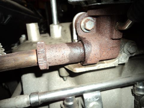 2004 Mercury Grand Marquis - Close-up view of a corroded exhaust pipe connection on an engine.