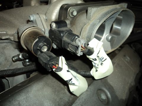 2004 Mercury Grand Marquis - Engine throttle body with sensors and wiring, showing modifications with white tape on the connectors.