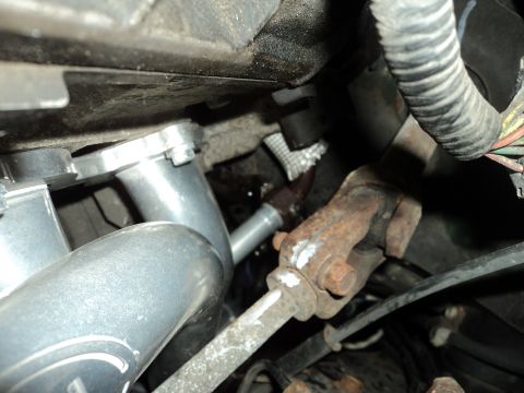 2004 Mercury Grand Marquis - Close-up view of engine components, including plumbing and a steering column part.