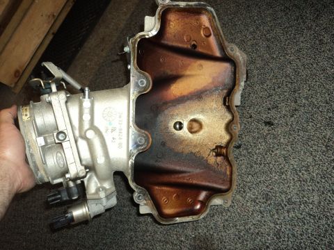 2004 Mercury Grand Marquis - A Ford throttle body and intake manifold assembly is shown, with visible oil residue in the manifold.