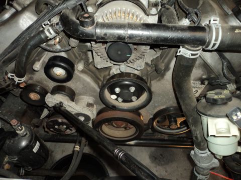 2004 Mercury Grand Marquis - Close-up view of engine components, including pulleys and hoses.