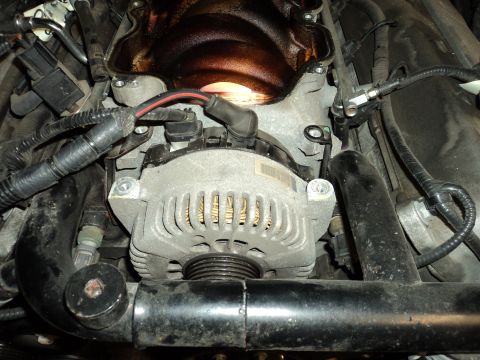 2004 Mercury Grand Marquis - Engine bay view showing an alternator and associated engine components.