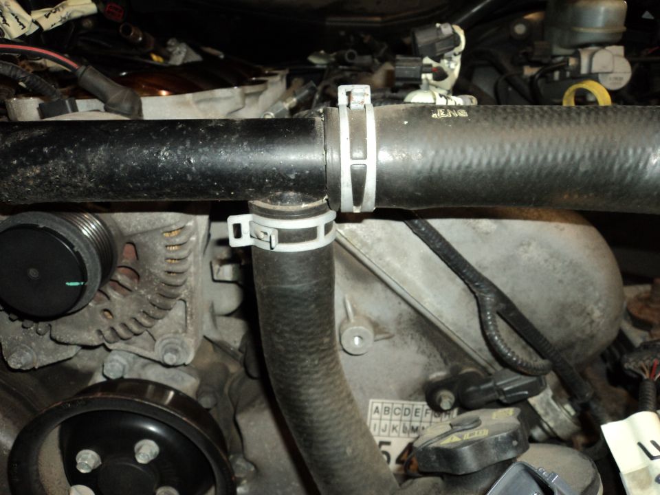 Engine hoses and alternator with visible text 'SUPERMOTORS.NET'