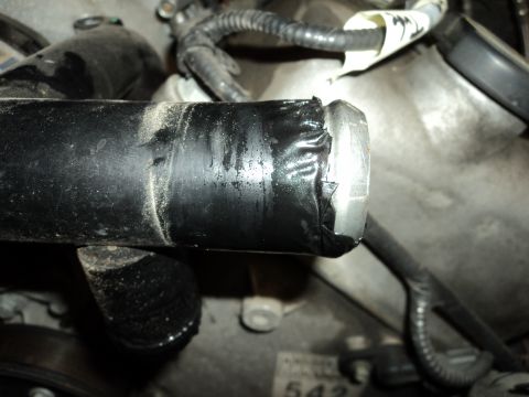 2004 Mercury Grand Marquis - Close-up of a worn engine hose repaired with electrical tape.