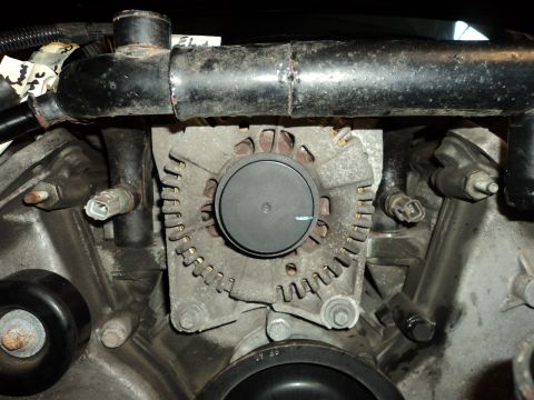 2004 Mercury Grand Marquis - Engine bay view showing an alternator and associated plumbing and electrical connections.