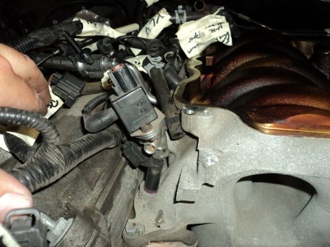 2004 Mercury Grand Marquis - Close-up view of engine components, including fuel injectors and wiring, with handwritten labels on tape.