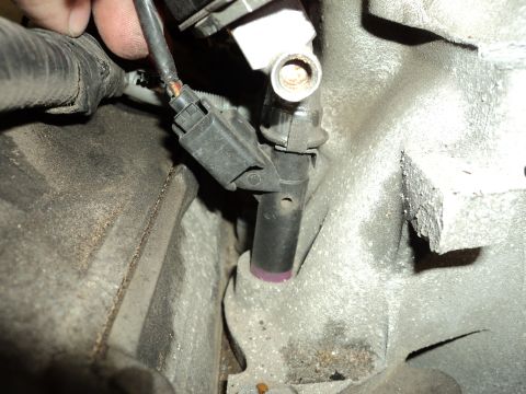 2004 Mercury Grand Marquis - Close-up of an engine component with visible wear and a disconnected electrical connector.