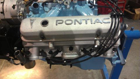 1972 Pontiac Trans Am - Close-up of a Pontiac V8 engine, silver valve covers and an Edelbrock intake manifold.