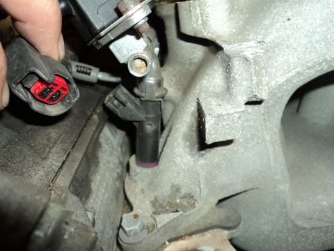 2004 Mercury Grand Marquis - Close-up of an engine component and an electrical connector, likely during maintenance or repair.