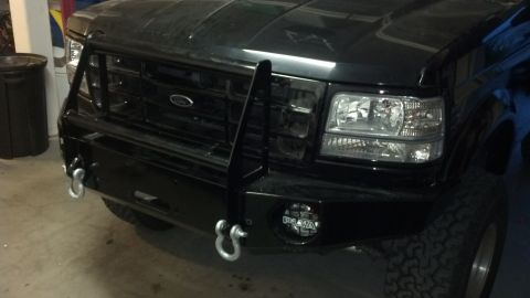 1995 Ford Bronco - Front view of a 1995 Ford Bronco, modified with a heavy-duty bumper and brush guard.