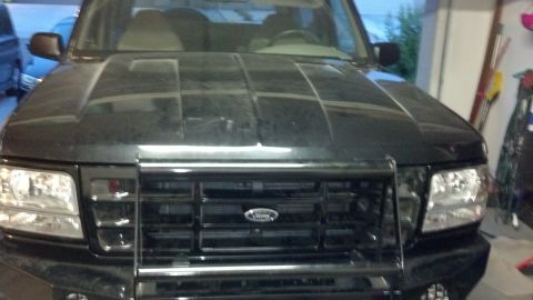 1995 Ford Bronco - Front view of a black Ford truck, identified as a 1998 model based on its grille design.