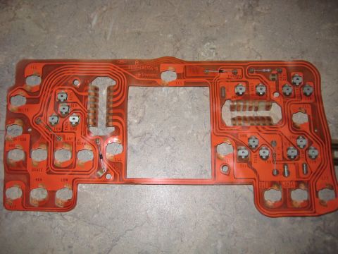 1996 Ford Bronco - This is a circuit board with many labels for vehicle functions, likely from a dashboard.