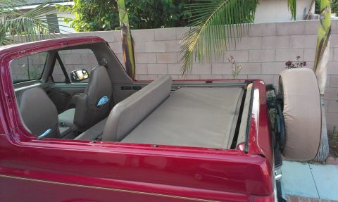 1994 Ford Bronco - This 1994 Ford Bronco features a removable top, offering an open-air driving experience and a clear view of its interior and rear-mounted s…