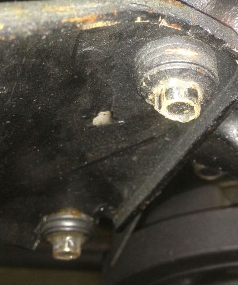 1978 Ford Bronco - Close-up view of the underside of a vehicle, highlighting bolts and accumulated oil, with a Supermotors.net watermark.