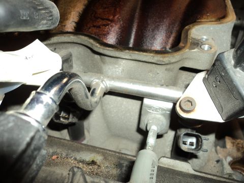 2004 Mercury Grand Marquis - A close-up view of engine components, focusing on the fuel rail and associated sensors and tubing.