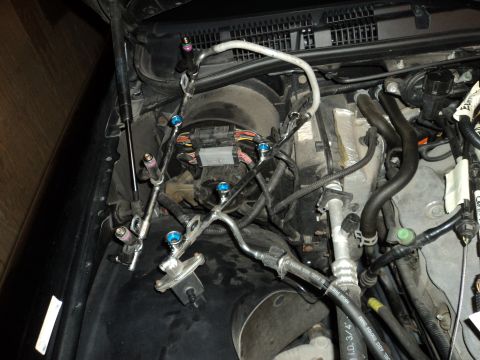 2004 Mercury Grand Marquis - Close-up view of engine bay components including fuel injectors and hoses.