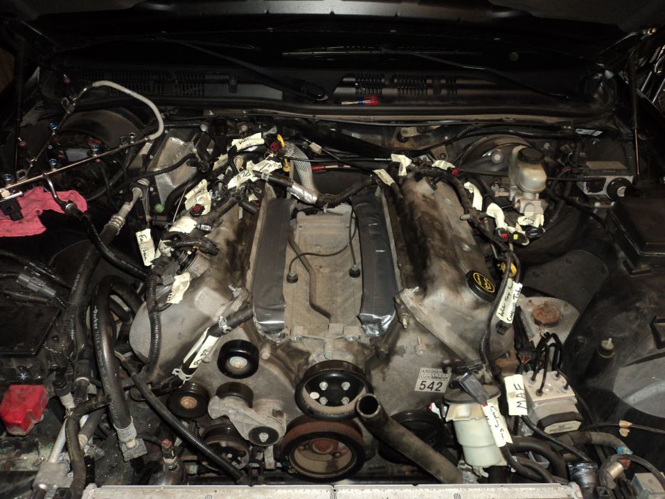 Engine bay with V8 engine, wiring harnesses, and various components. A "SUPERMOTORS.NET" watermark is visible