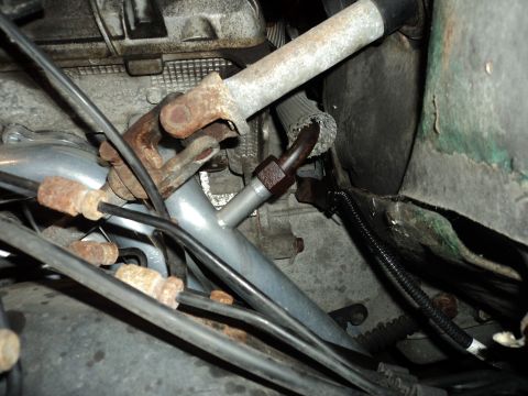 2004 Mercury Grand Marquis - Underside view of engine bay showing steering linkage, hoses, and wiring harness.