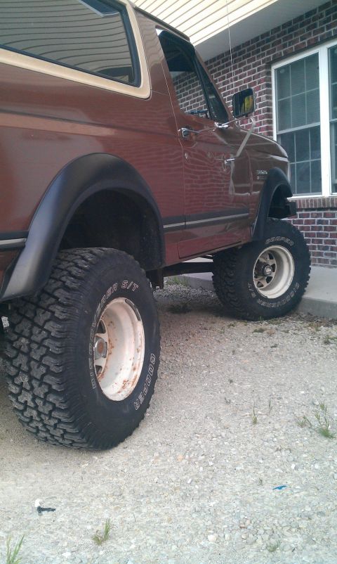 1987 Ford Bronco - This 1987 Ford Bronco features a lifted suspension and aggressive off-road tires, giving it a commanding presence.