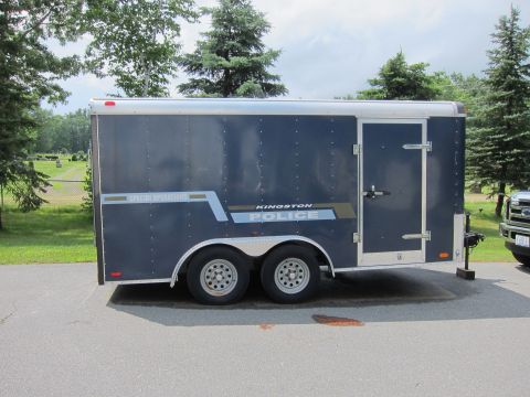 2001 Ford Crown Victoria - A dark blue trailer with "KINGSTON POLICE" and "SPECIAL OPERATIONS" markings is parked outdoors.