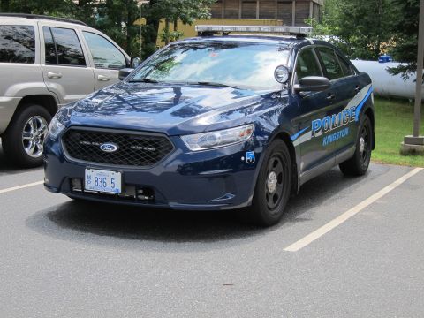 2001 Ford Crown Victoria - A Ford Police Interceptor sedan is parked next to a silver SUV in a parking lot.