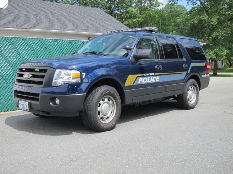 2001 Ford Crown Victoria - A blue Ford Expedition SUV, marked as a Kingston Police vehicle, is parked on asphalt.