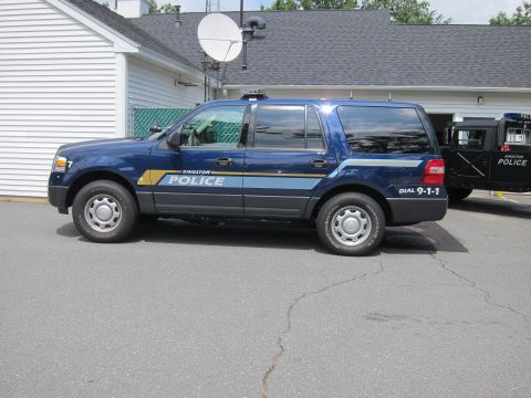 2001 Ford Crown Victoria - A Kingston Police Ford Expedition SUV is parked next to another police vehicle.
