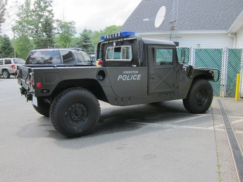 2001 Ford Crown Victoria - Photo of a Kingston Police military-style Humvee, not a technical document.
