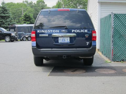 2001 Ford Crown Victoria - The rear of a dark-colored SUV is shown, parked in an outdoor lot.