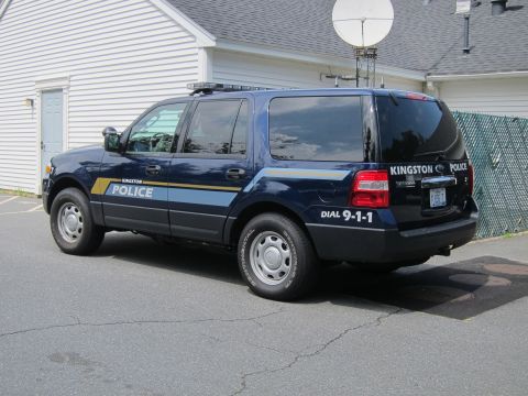 2001 Ford Crown Victoria - A dark blue SUV is seen from the rear quarter angle in this photograph.