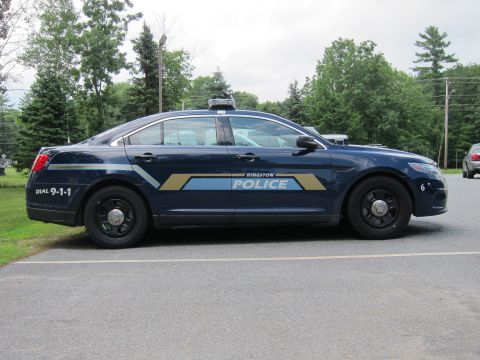 2001 Ford Crown Victoria - Side view of a dark blue 2001 Ford Crown Victoria police car parked outdoors.