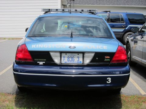 2001 Ford Crown Victoria - Kingston Police Ford Crown Victoria, unit 3, parked next to another police vehicle.